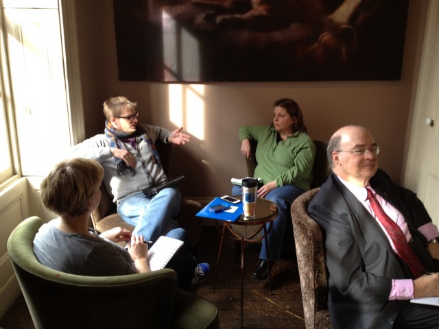 One group discusses, while the presenter listens in with their back turned.